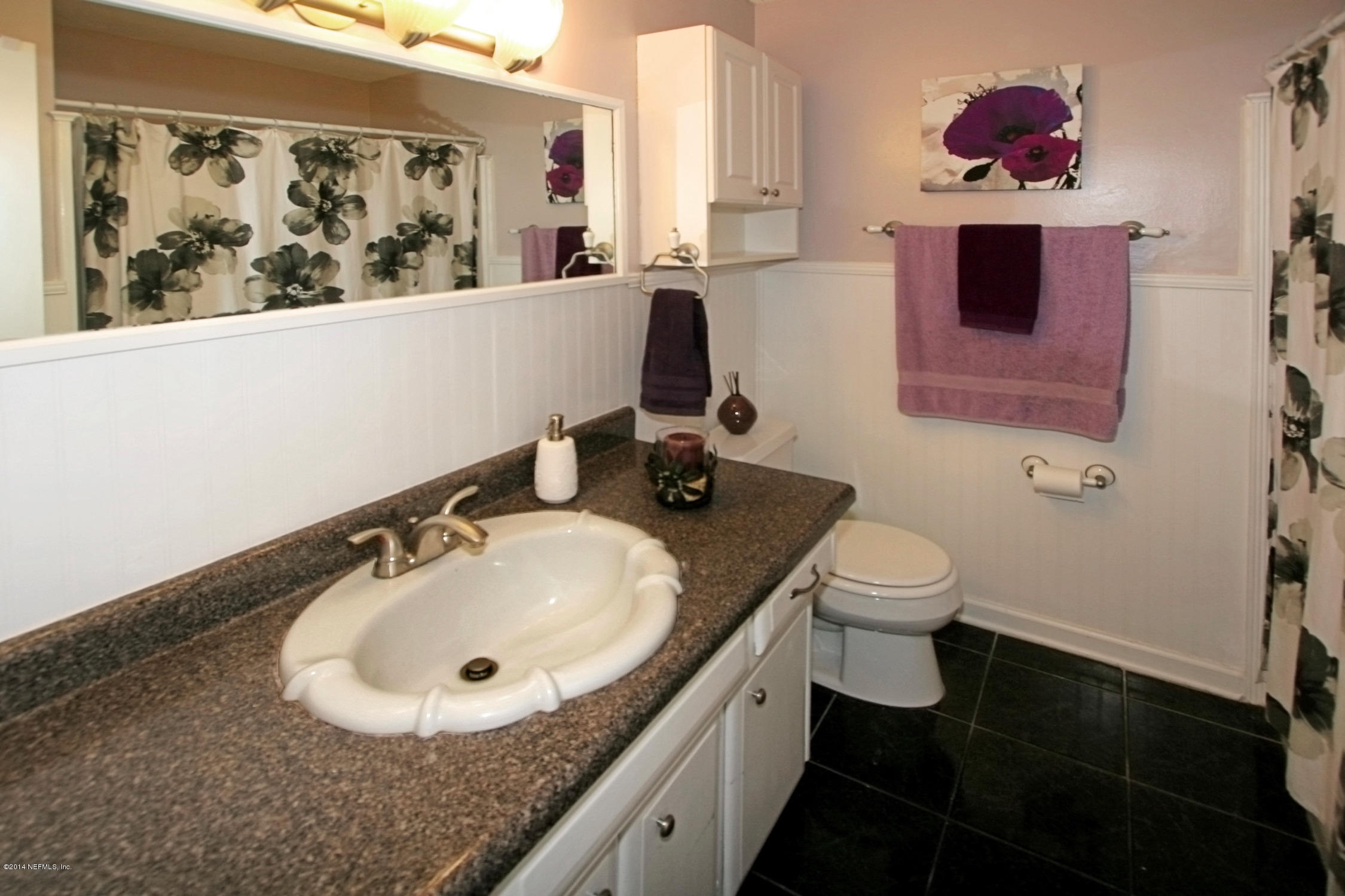 6404 Heidi Road Jacksonville, FL 32277 - Photo 19 of 26 a bathroom with a sink mirror and toilet