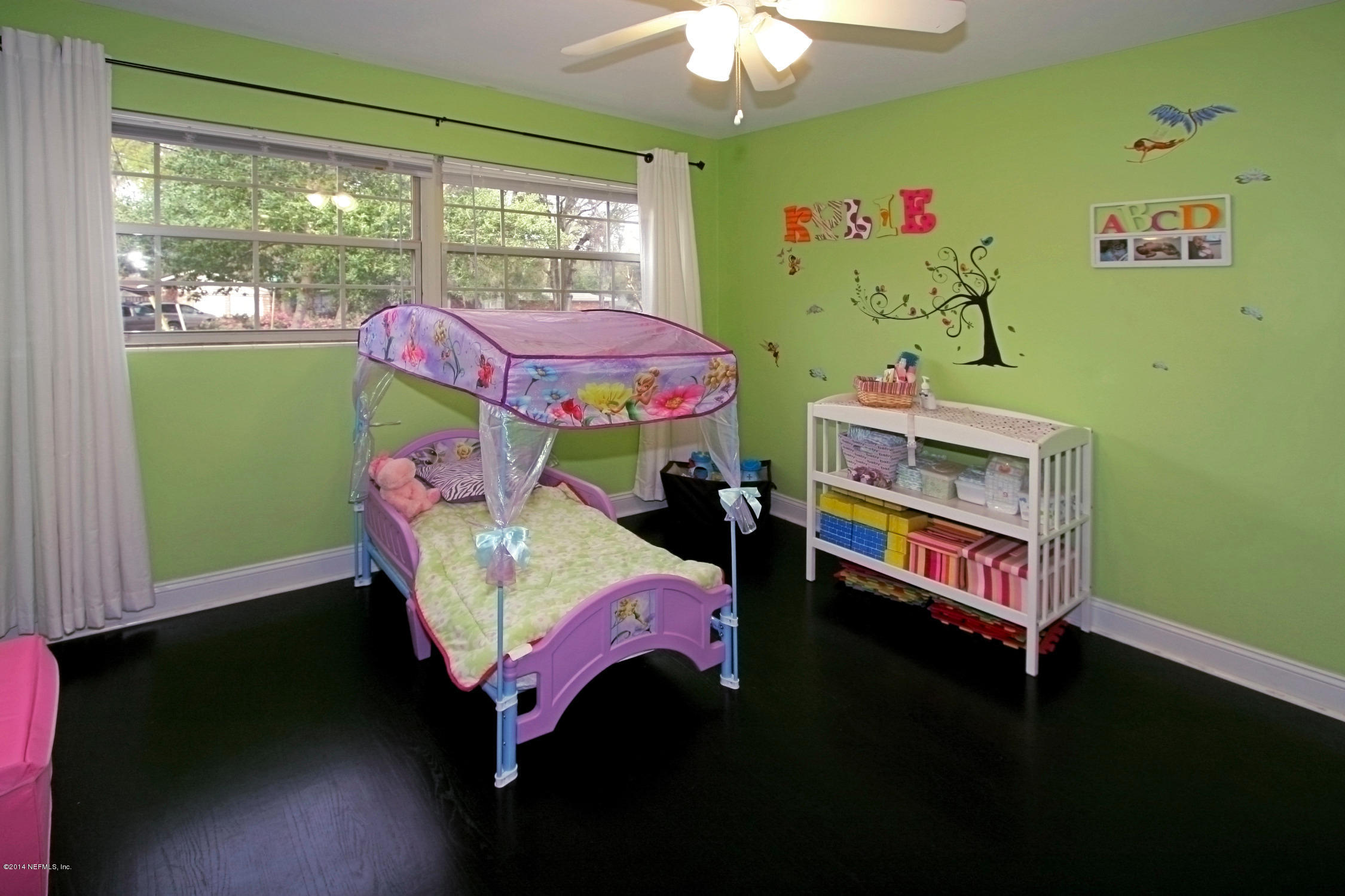 6404 Heidi Road Jacksonville, FL 32277 - Photo 20 of 26 a bedroom with a bed and a window