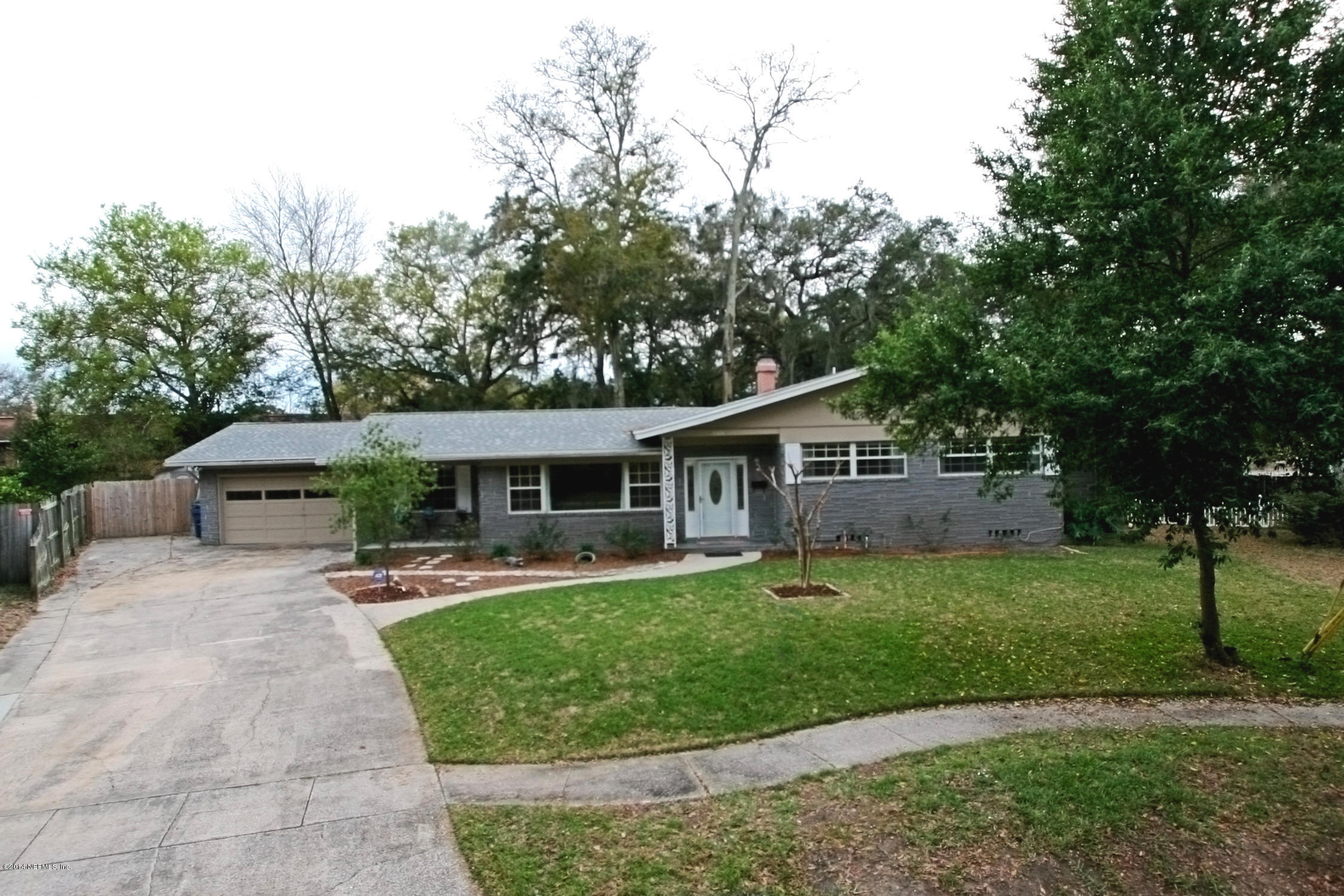 6404 Heidi Road Jacksonville, FL 32277 - Photo 2 of 26 a front view of a house with a yard and trees
