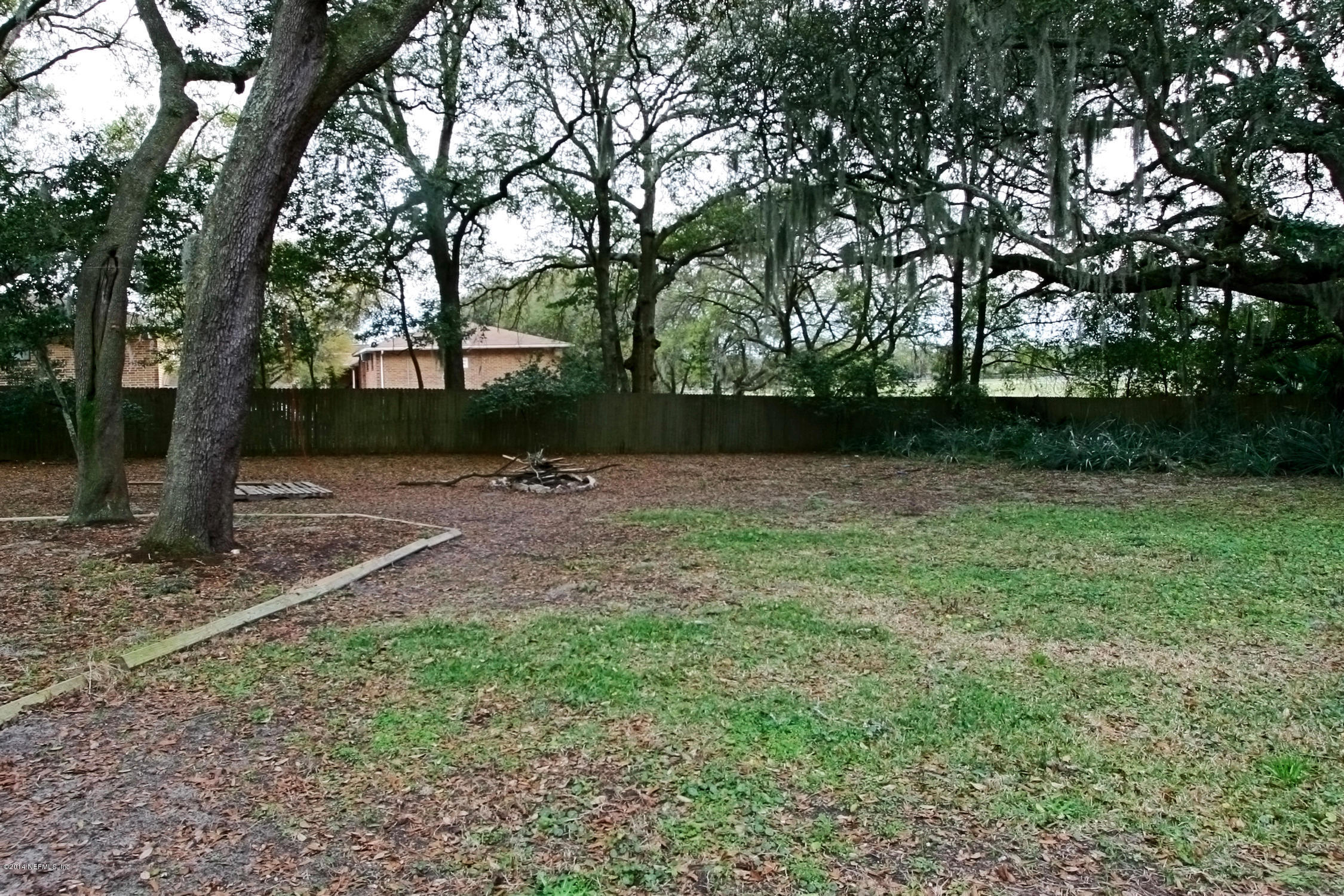 6404 Heidi Road Jacksonville, FL 32277 - Photo 25 of 26 a backyard of a house with lots of green space