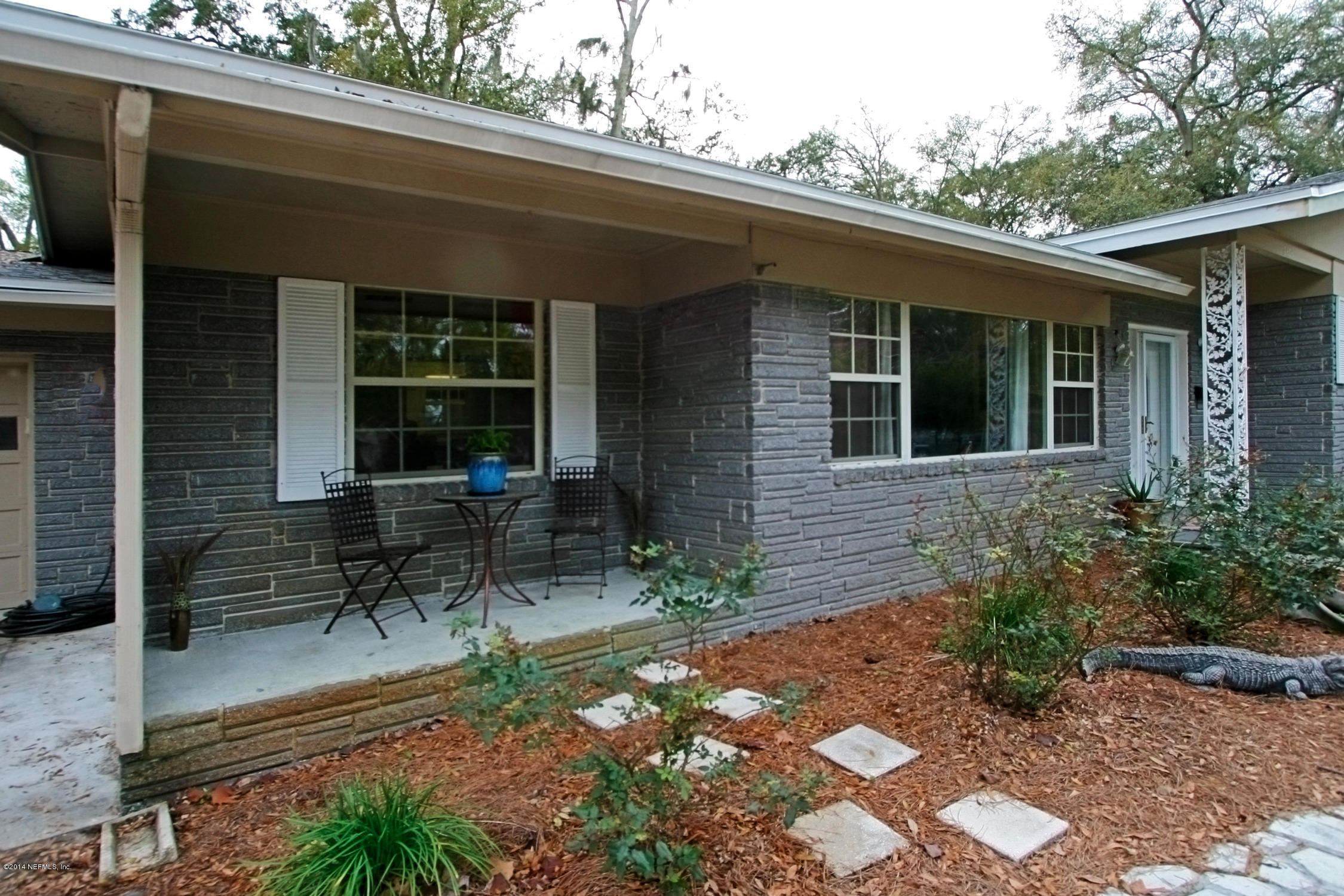 6404 Heidi Road Jacksonville, FL 32277 - Photo 3 of 26 a front view of a house with a garden