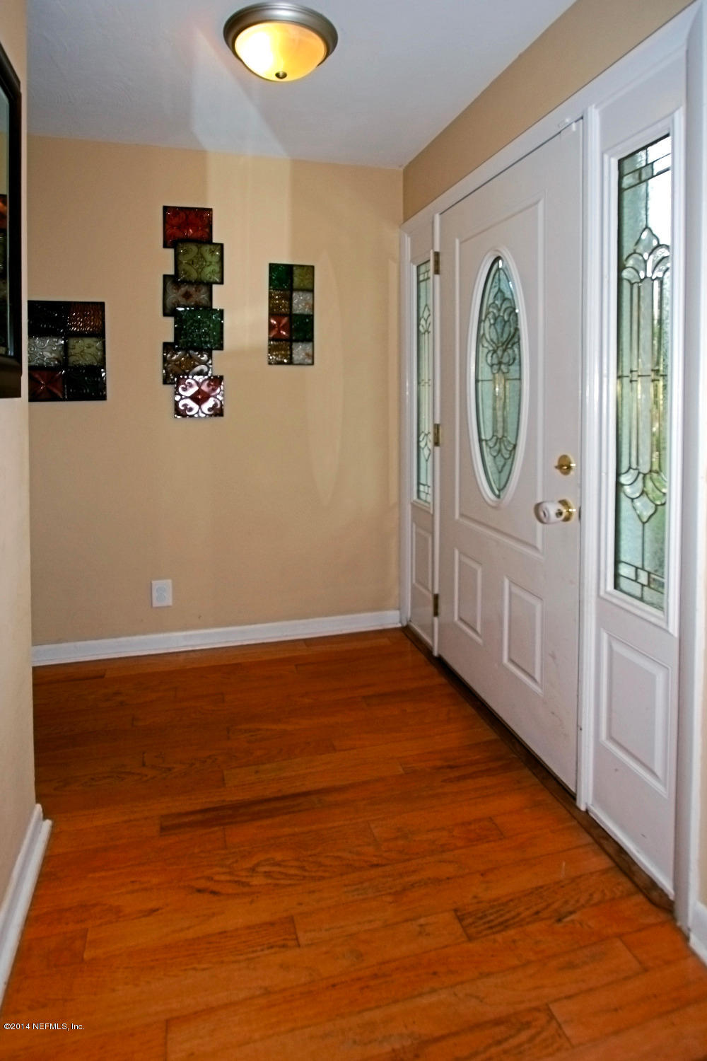 6404 Heidi Road Jacksonville, FL 32277 - Photo 4 of 26 a view of empty room with wooden floor and window