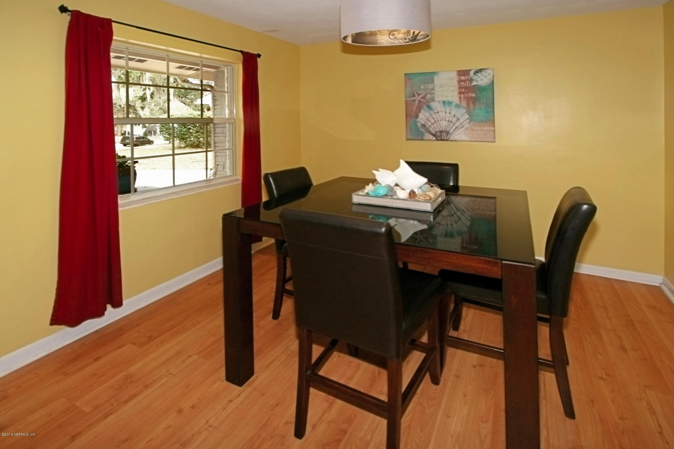 6404 Heidi Road Jacksonville, FL 32277 - Photo 8 of 26 a view of a dining room with furniture window and wooden floor