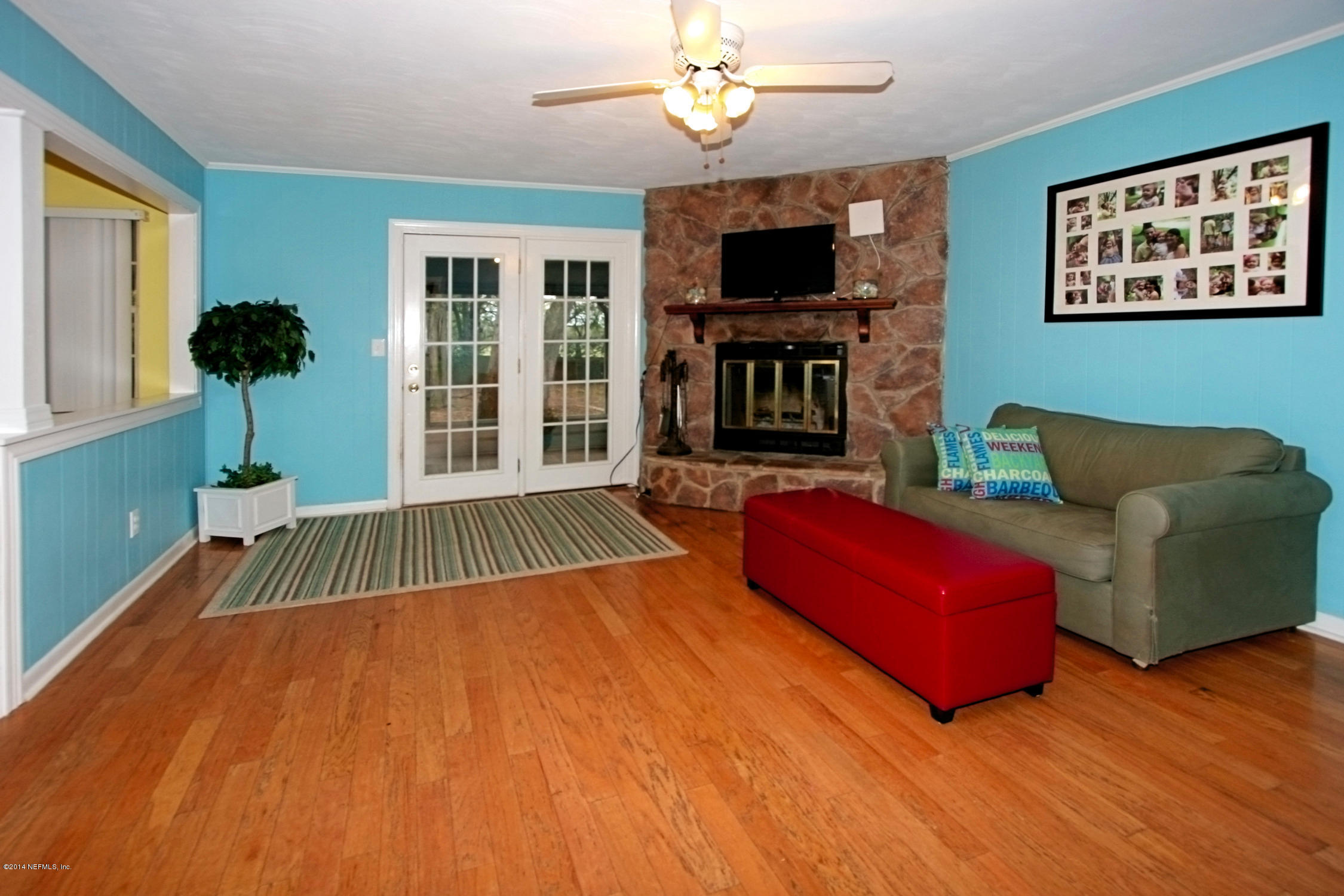 6404 Heidi Road Jacksonville, FL 32277 - Photo 9 of 26 a living room with furniture and a flat screen tv