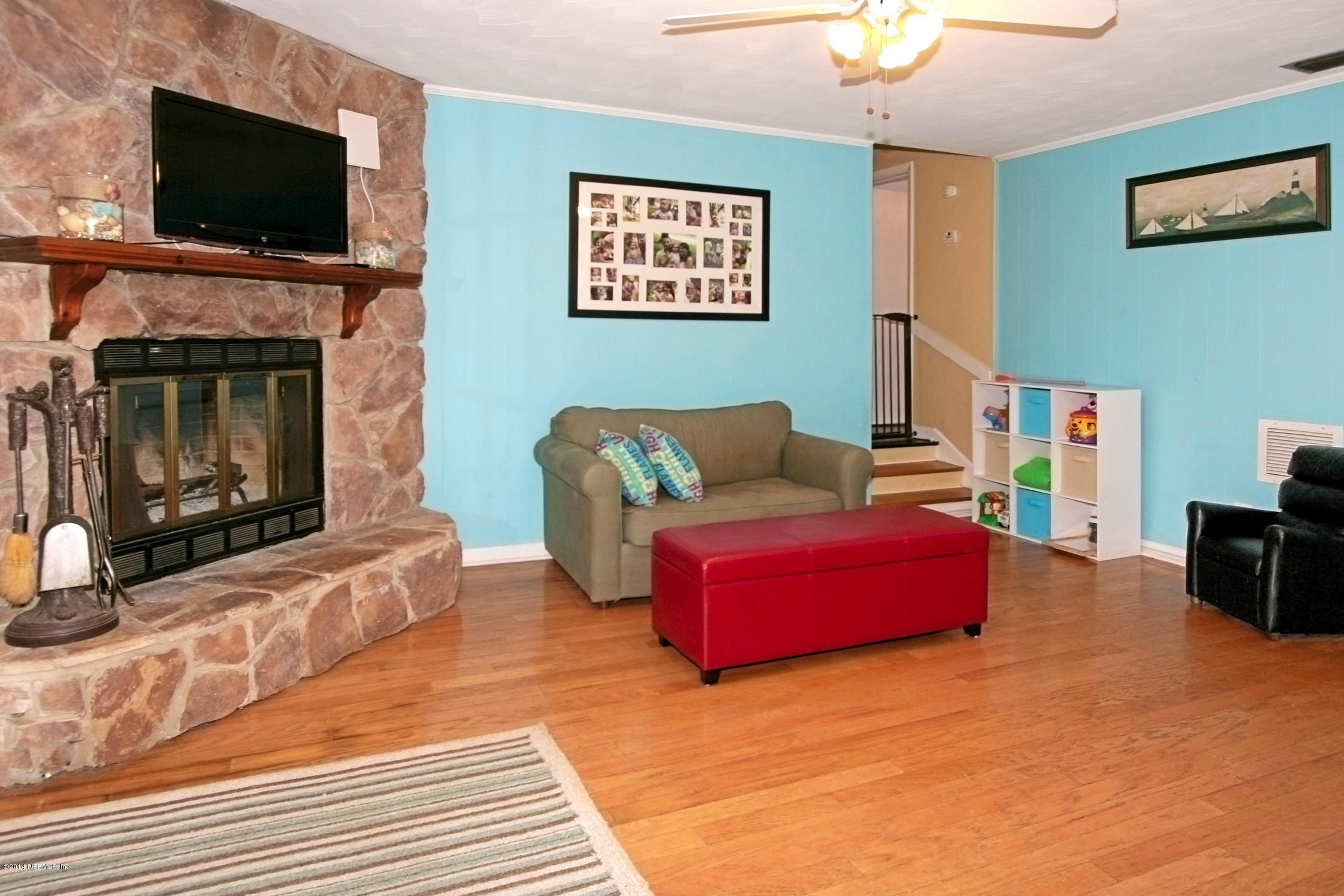 6404 Heidi Road Jacksonville, FL 32277 - Photo 10 of 26 a living room with furniture and a flat screen tv