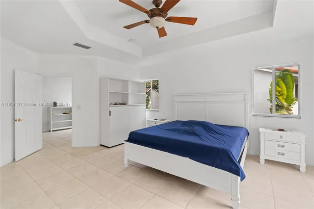 a spacious bedroom with a bed and a cabinets