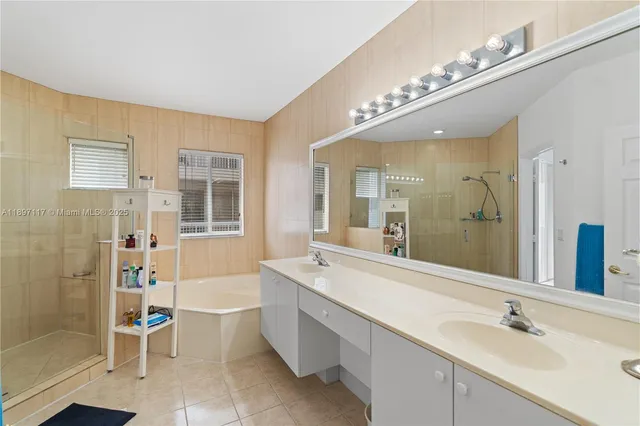 a spacious bathroom with a shower a sink and a mirror