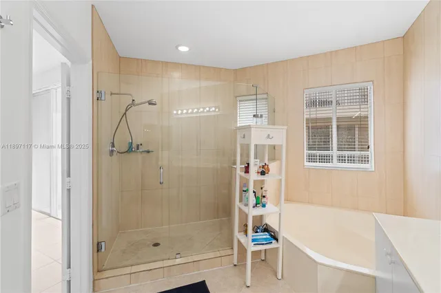 a bathroom with a bathtub and shower