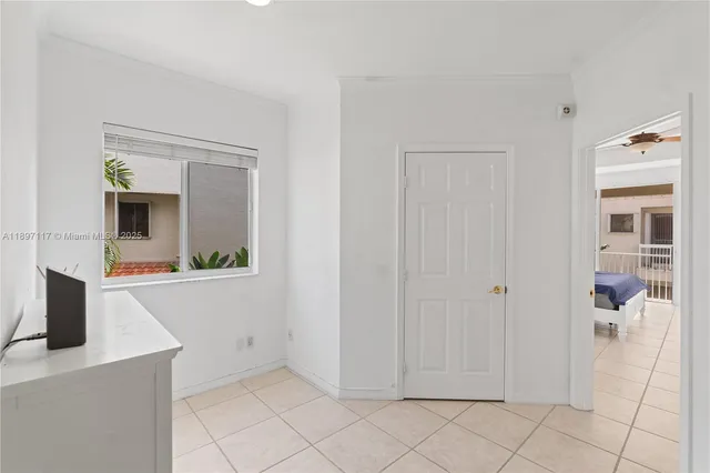 a view of a hallway with bathroom and mirror