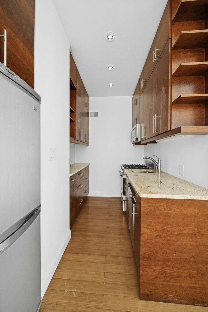159 Madison Avenue, Unit 9B Manhattan, NY 10016 - Photo 11 of 16 a kitchen with a sink stove and cabinets