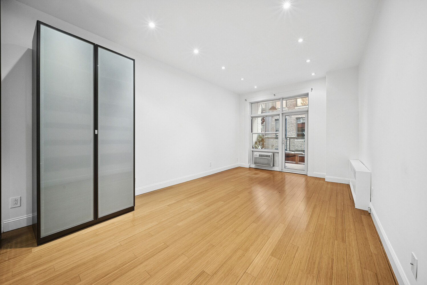 159 Madison Avenue, Unit 9B Manhattan, NY 10016 - Photo 2 of 16 a view of empty room with wooden floor and fan