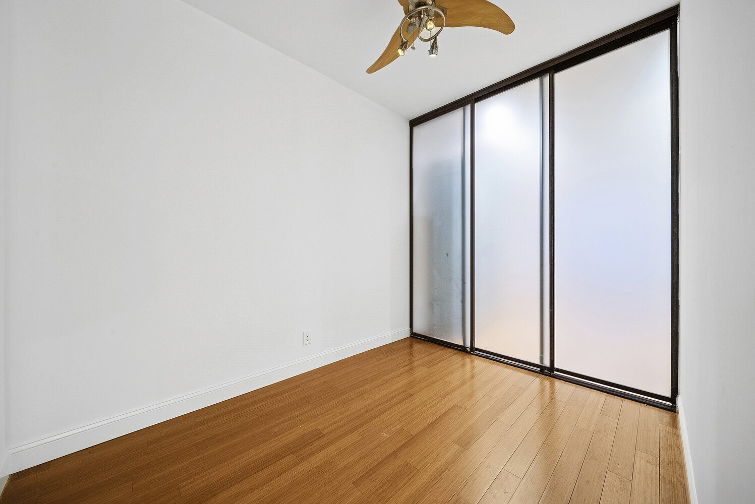 159 Madison Avenue, Unit 9B Manhattan, NY 10016 - Photo 7 of 16 a view of an empty room with wooden floor and a window
