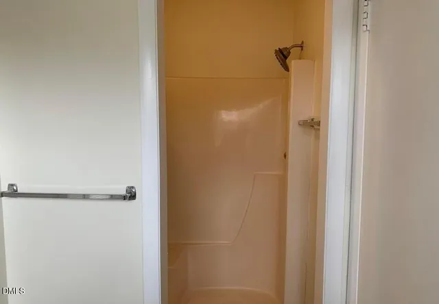 a bathroom with a glass shower door