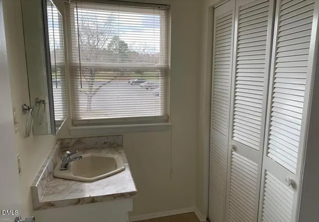 a bathroom with a sink a vanity and a window