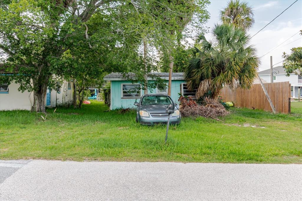 5323 Circle Drive Weeki Wachee, FL 34607 - Photo 36 of 77 a backyard of a house with barbeque oven table and chairs