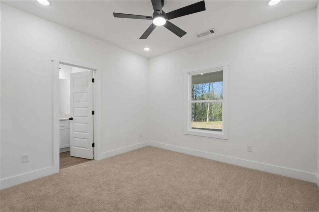 11691 Hazelbrand Road Northeast Covington, GA 30014 - Photo 23 of 53 an empty room with a window and a ceiling fan