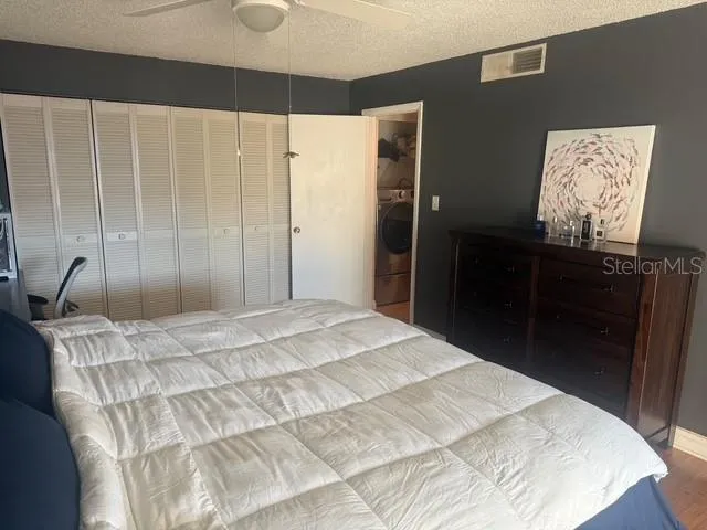 a bedroom with a bed and a mirror