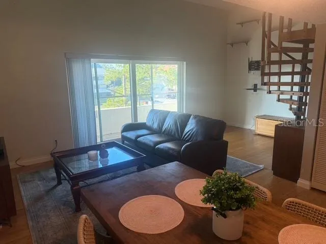 a living room with furniture and a potted plant