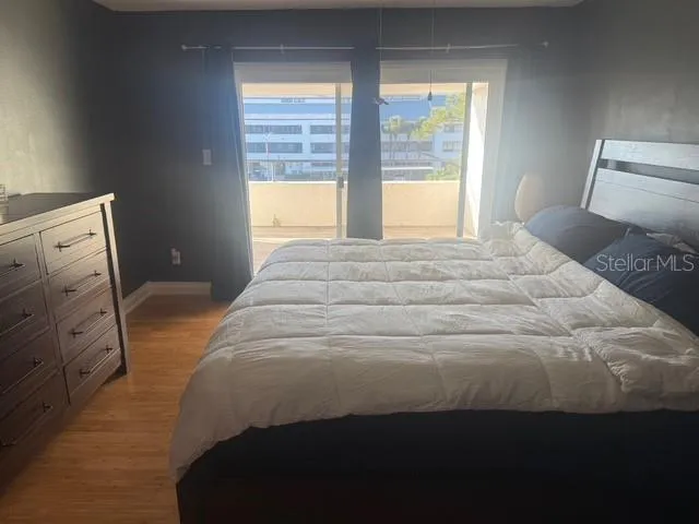 a bedroom with a bed and a large window