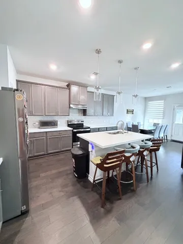 a kitchen with a table chairs a sink and appliances
