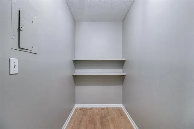 an empty room with windows and closet