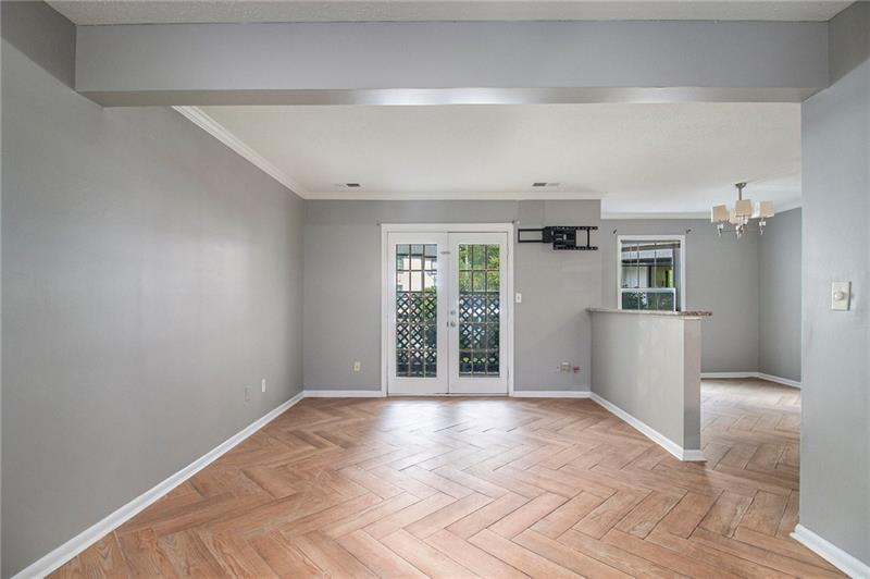 3599 Woodbriar Circle, Unit A Tucker, GA 30084 - Photo 8 of 30 a view of an empty room with wooden floor and a window