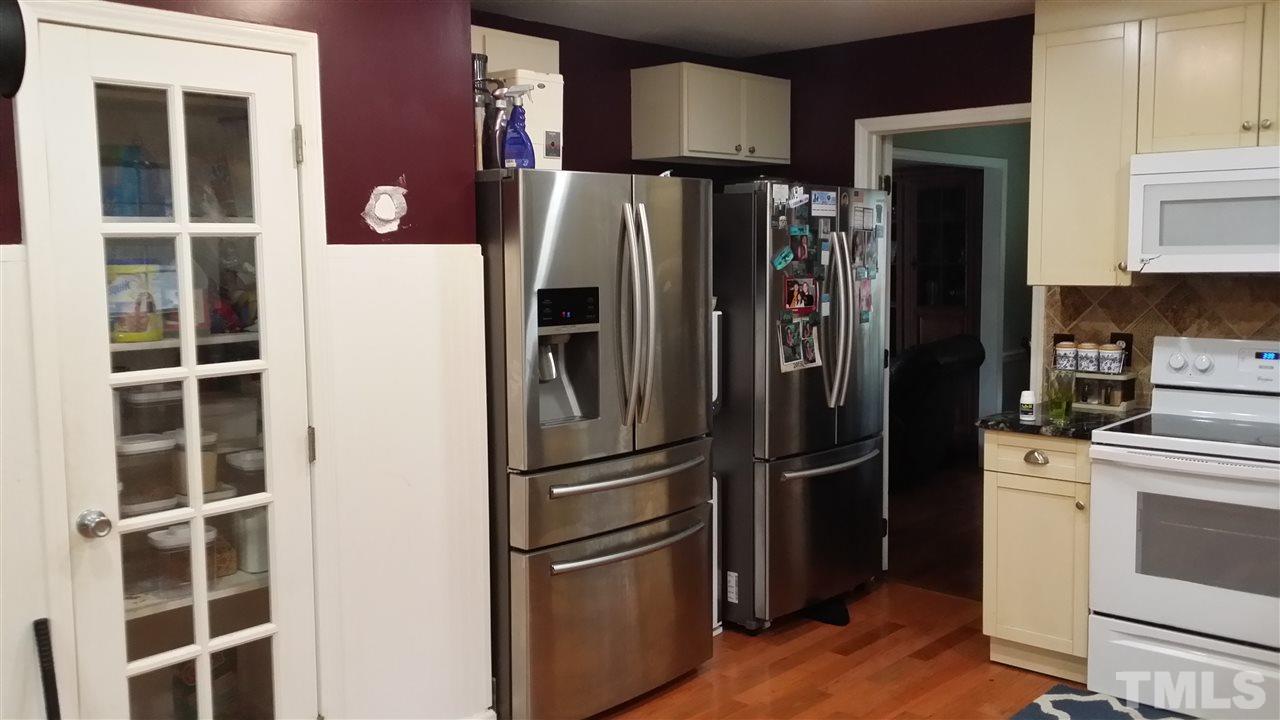 5404 Live Oak Trail Raleigh, NC 27613 - Photo 11 of 14 a metallic refrigerator freezer sitting in a kitchen