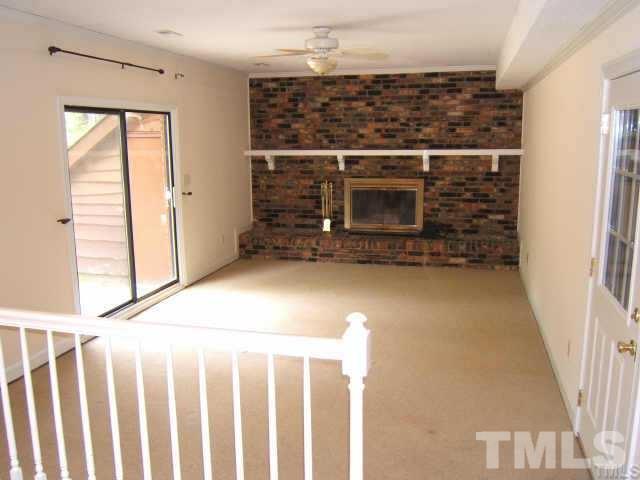 5404 Live Oak Trail Raleigh, NC 27613 - Photo 14 of 14 a view of a hallway with wooden floor and a fireplace