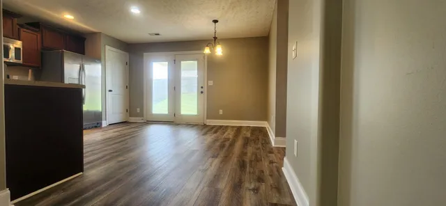 a view of hallway with wooden floor