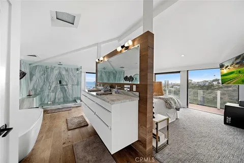 a large white kitchen with a large window and sink