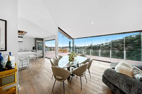 a dining room with furniture and wooden floor