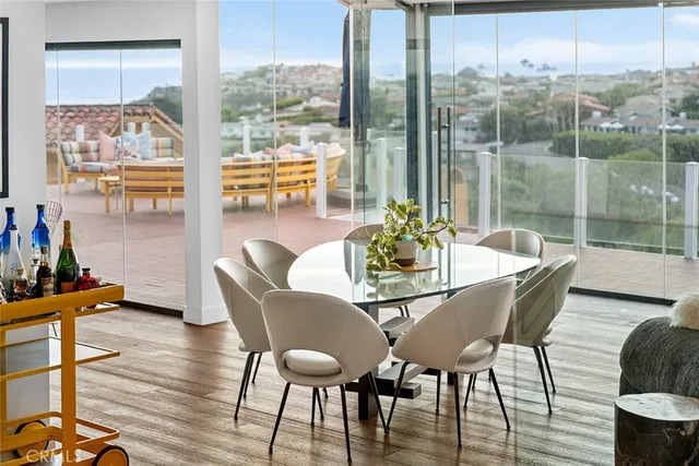 a dining room with furniture a chandelier and wooden floor