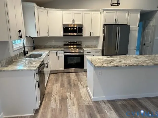 a kitchen with stainless steel appliances granite countertop a refrigerator stove and sink