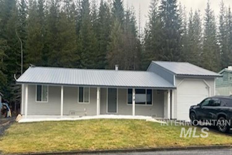 179 Timberline Drive Pierce, ID 83546 - Photo 1 of 24 Ranch-style home featuring a garage, covered porch, a front lawn, and a standing seam roof
