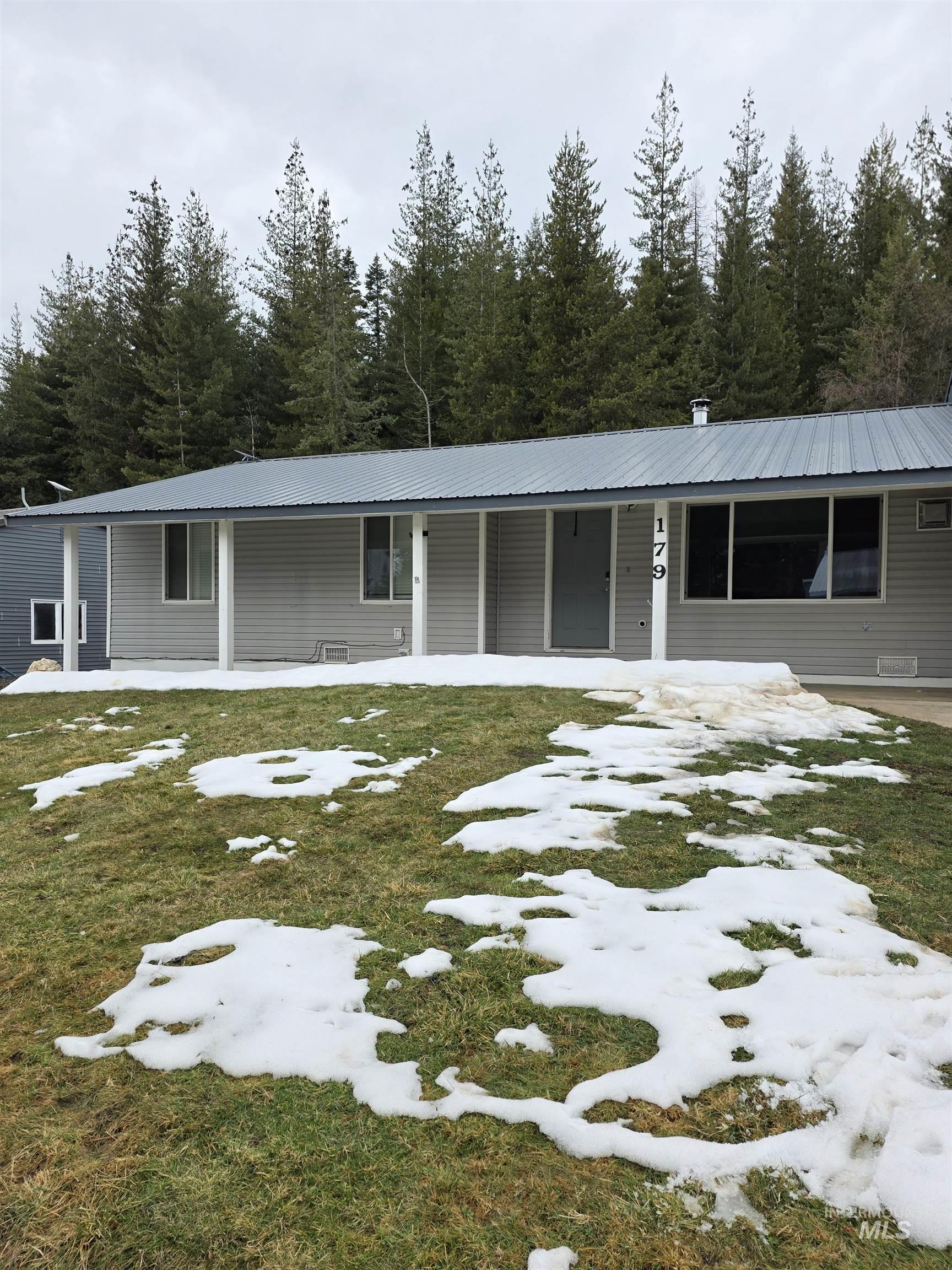 179 Timberline Drive Pierce, ID 83546 - Photo 2 of 24 View of front of house with covered porch and a lawn