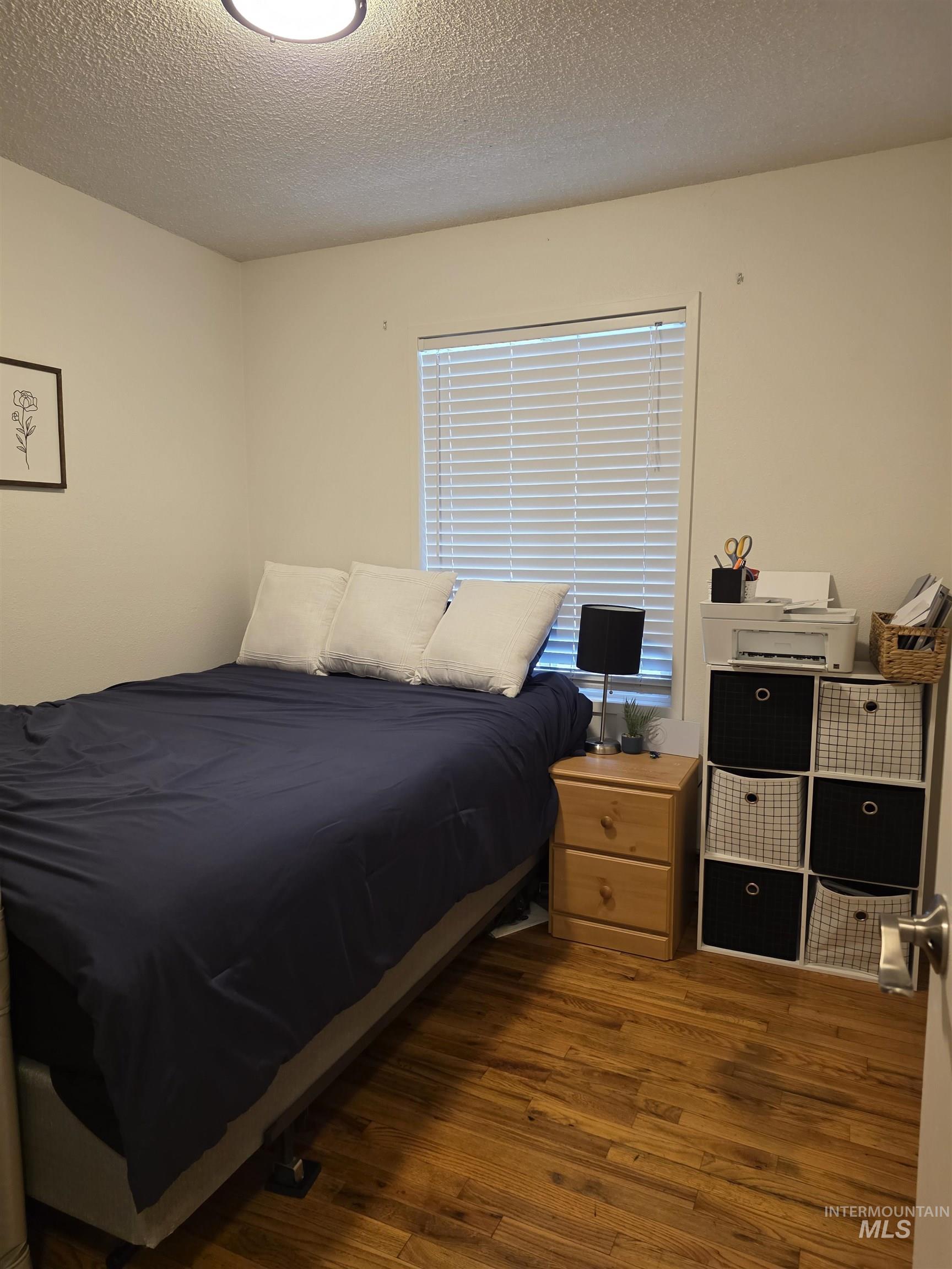 179 Timberline Drive Pierce, ID 83546 - Photo 21 of 24 Bedroom with dark wood-style flooring and a textured ceiling