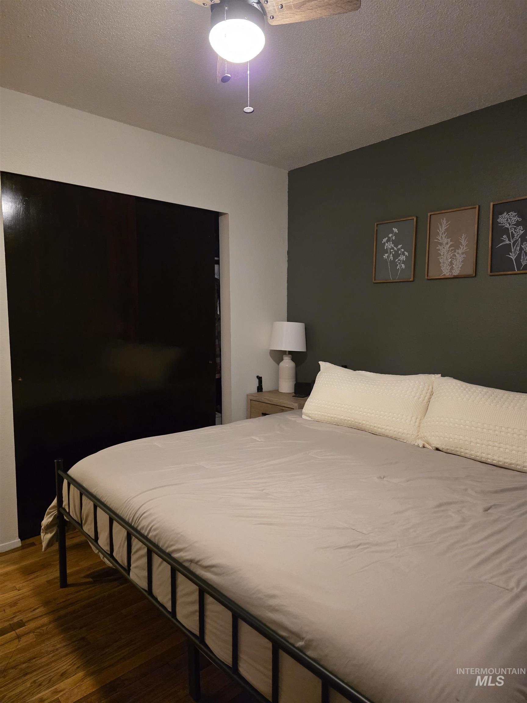 179 Timberline Drive Pierce, ID 83546 - Photo 23 of 24 Bedroom featuring wood finished floors, a textured ceiling, and a ceiling fan