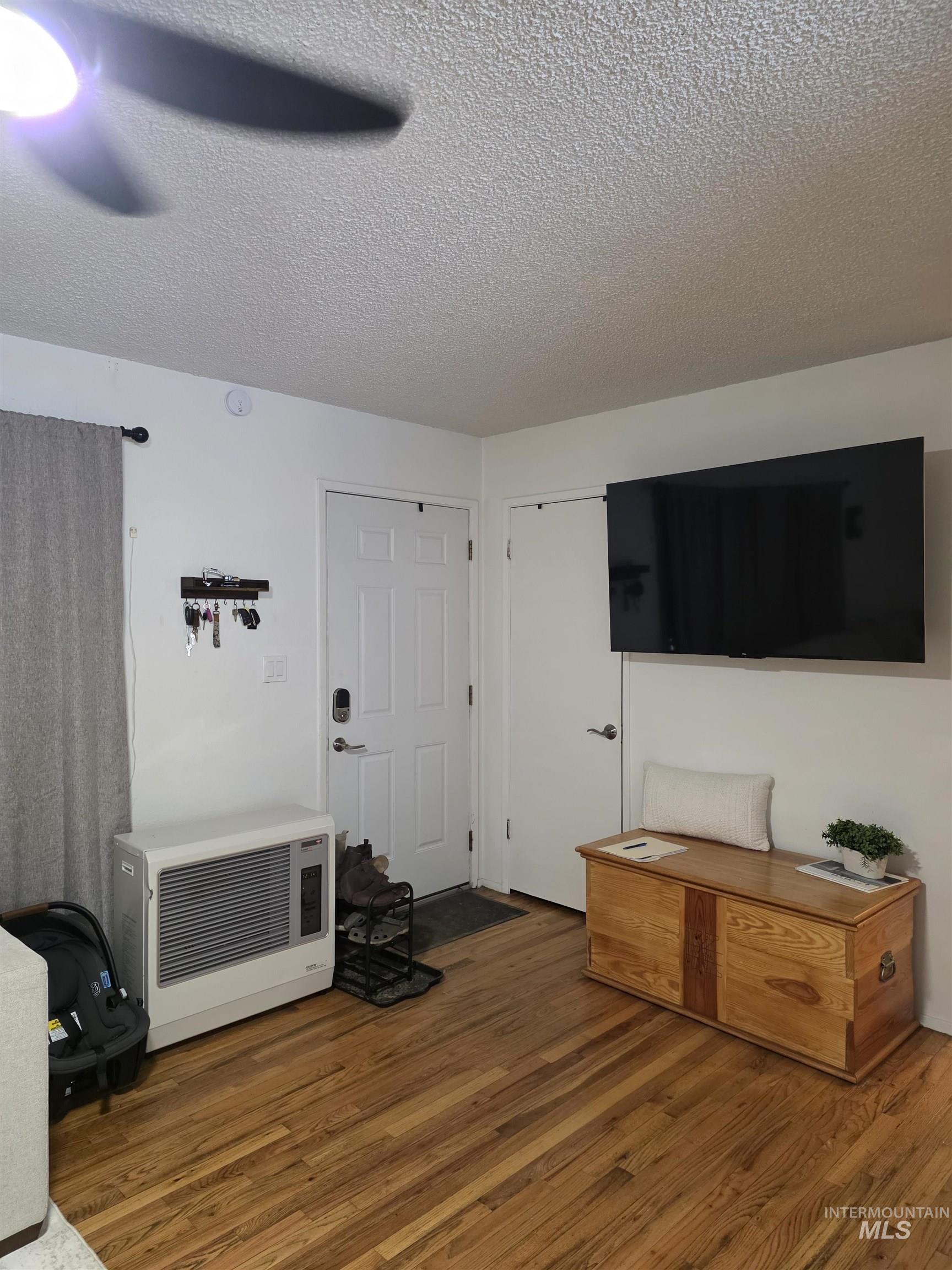179 Timberline Drive Pierce, ID 83546 - Photo 10 of 24 Bedroom with a textured ceiling, wood finished floors, and a ceiling fan
