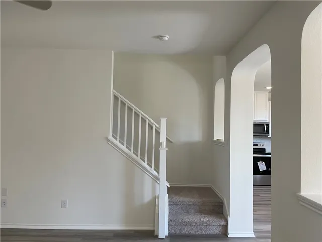 a view of staircase with white walls and windows