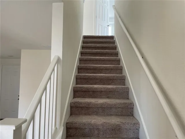 a view of staircase with white walls