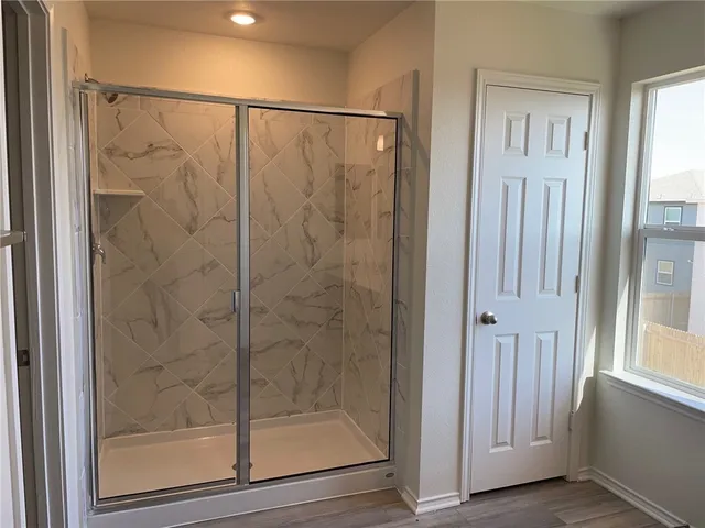 a bathroom with a glass shower door