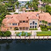 an aerial view of residential houses with outdoor space and swimming pool