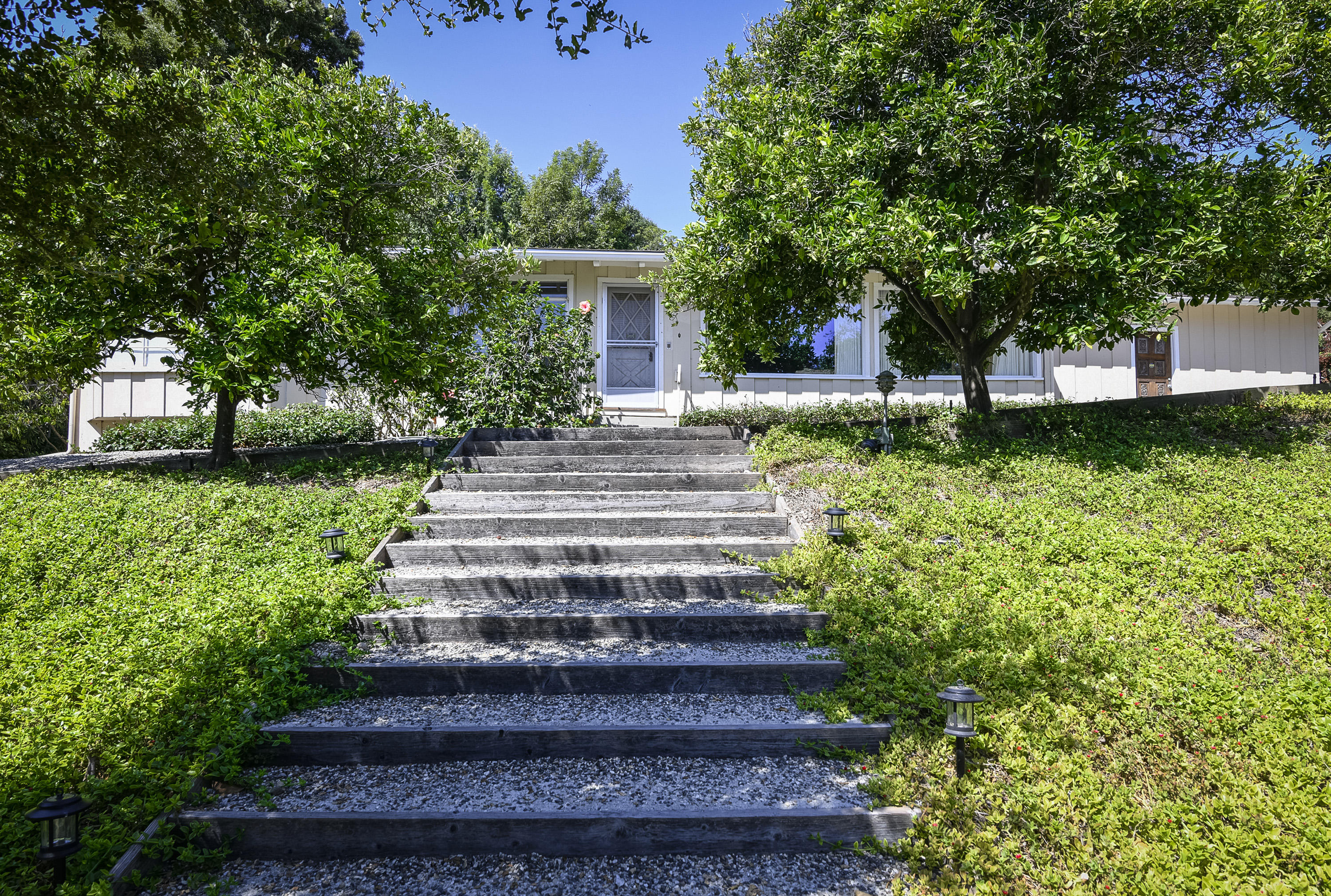 725 El Rancho Road Santa Barbara, CA 93108 - Photo 3 of 13 a front view of a house with garden