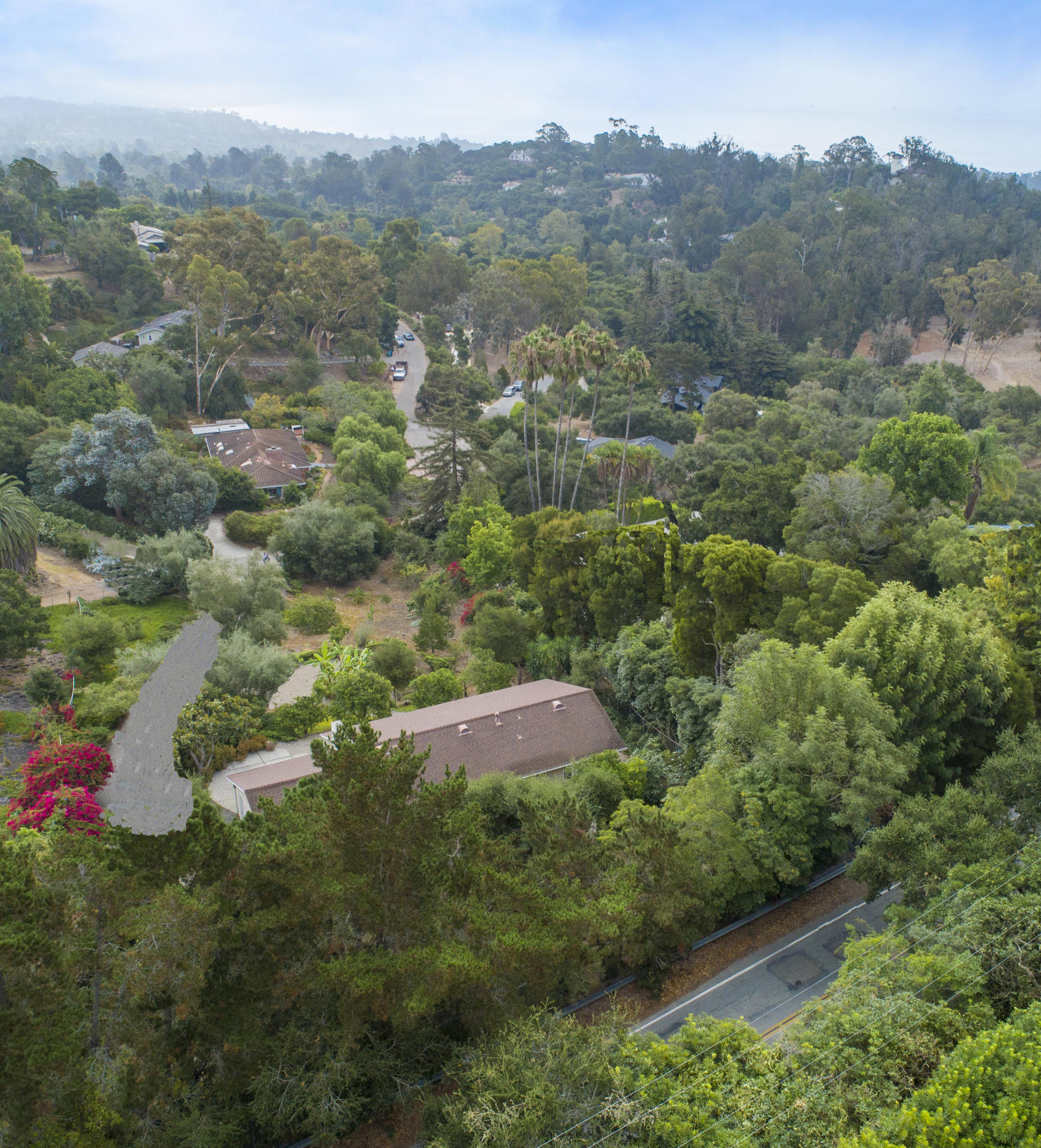 725 El Rancho Road Santa Barbara, CA 93108 - Photo 8 of 13 an aerial view of green landscape with trees houses and mountain view