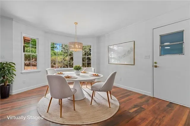 a dining room with furniture a rug and wooden floor