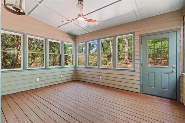 a view of lot of wooden floor and windows in a room