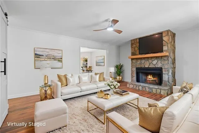 a living room with furniture and a fireplace