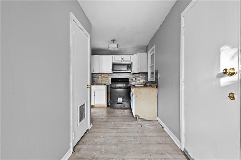 685 Bolton Road Northwest Atlanta, GA 30331 - Photo 7 of 21 a kitchen with granite countertop a stove top oven and cabinets