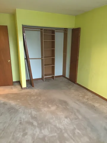 a view of an empty room with wooden door