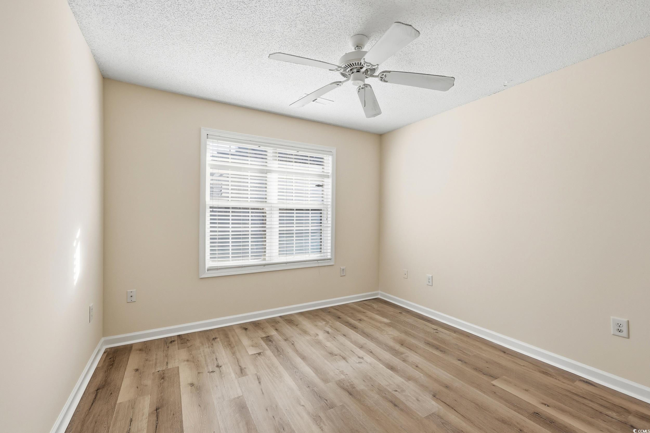 323 Chastain Court Murrells Inlet, SC 29576 - Photo 16 of 37 Spare room featuring light wood-style flooring, ceiling fan, and vaulted ceiling